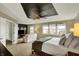 Bright main bedroom with natural light, a decorative tray ceiling, and a separate lounge area at 10235 Normandy Way, Fishers, IN 46040