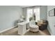 Bright office space with a large window, white desk, and cozy seating area, perfect for working from home at 10235 Normandy Way, Fishers, IN 46040