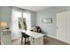 Bright home office with white desk, chair, and a comfortable reading nook near the window at 10235 Normandy Way, Fishers, IN 46040
