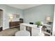 Spacious home office featuring a white desk, ample storage, and a comfortable seating area at 10235 Normandy Way, Fishers, IN 46040