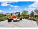 Outdoor patio with orange seating, accent pillows, and manicured landscaping at 10235 Normandy Way, Fishers, IN 46040