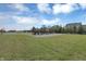 Community playground on a green lawn, complete with a basketball court at 10235 Normandy Way, Fishers, IN 46040