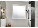 Modern shower featuring white subway tiles, black fixtures, frosted window, and glass enclosure at 10235 Normandy Way, Fishers, IN 46040