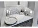 Stylish wet bar features mosaic backsplash, quartz countertop, wine storage, and is great for entertaining at 10235 Normandy Way, Fishers, IN 46040