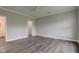 Spacious bedroom with wood-look floors, ceiling fan, and neutral paint at 1200 Shadow Ridge Rd, Carmel, IN 46280