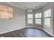 Bright dining area with hardwood floors and three windows, modern chandelier and view into kitchen at 1200 Shadow Ridge Rd, Carmel, IN 46280