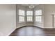 Dining area featuring three windows, hardwood floors, and a contemporary chandelier at 1200 Shadow Ridge Rd, Carmel, IN 46280