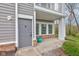 Close-up of front entryway with stylish door, small patio, and neat landscaping around the home at 1200 Shadow Ridge Rd, Carmel, IN 46280