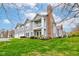 Attractive townhome with gray siding, brick chimney, and green lawn, complemented by a second-story balcony at 1200 Shadow Ridge Rd, Carmel, IN 46280