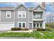 Stylish townhome with gray siding, showcasing a charming balcony and well-maintained landscaping at 1200 Shadow Ridge Rd, Carmel, IN 46280