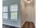 Inviting entryway featuring dark wood floors, large windows with blinds, and a modern chandelier at 1200 Shadow Ridge Rd, Carmel, IN 46280