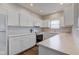 Kitchen featuring white cabinets, stainless steel appliances, and light countertops at 1200 Shadow Ridge Rd, Carmel, IN 46280