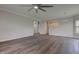 Expansive living area with dark wood floors, modern lighting, and open view into the kitchen at 1200 Shadow Ridge Rd, Carmel, IN 46280