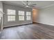 Spacious living room features dark wood floors, a modern ceiling fan, and large windows at 1200 Shadow Ridge Rd, Carmel, IN 46280