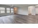 Spacious living room featuring hardwood floors, neutral walls, and abundant natural light from several windows at 1200 Shadow Ridge Rd, Carmel, IN 46280