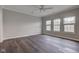 Large main bedroom with hardwood floors, neutral walls, ceiling fan and three large windows at 1200 Shadow Ridge Rd, Carmel, IN 46280