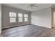 Bedroom with hardwood floors, ceiling fan and three large windows at 1200 Shadow Ridge Rd, Carmel, IN 46280