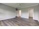 Spacious bedroom featuring hardwood floors, neutral walls, and two entry doors at 1200 Shadow Ridge Rd, Carmel, IN 46280