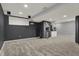 Finished basement space with carpeting and a kitchenette area for entertaining at 12027 Sellerton Dr, Fishers, IN 46037