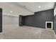 View of the basement's finished area, showing the neutral carpeting and column support at 12027 Sellerton Dr, Fishers, IN 46037