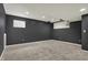 Finished basement area featuring neutral carpeting, recessed lighting, and dark gray walls at 12027 Sellerton Dr, Fishers, IN 46037