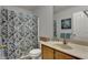 This bathroom has a neutral colored shower curtain and earth tones for a calming effect at 12027 Sellerton Dr, Fishers, IN 46037