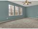 Bedroom featuring a ceiling fan, plush carpeting, and ample natural light from the three windows at 12027 Sellerton Dr, Fishers, IN 46037