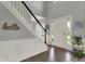 Bright foyer featuring hardwood floors, a staircase with white banister, and natural light at 12027 Sellerton Dr, Fishers, IN 46037