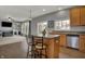 Kitchen with island and stool seating, hardwood flooring, and views of adjacent living space at 12027 Sellerton Dr, Fishers, IN 46037