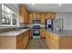 View of the kitchen with stainless steel appliances, granite countertops, and hardwood floors at 12027 Sellerton Dr, Fishers, IN 46037