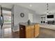 Kitchen island with granite countertops and wooden cabinets leading to the living room at 12027 Sellerton Dr, Fishers, IN 46037