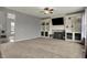 Large living room with custom built-ins, modern carpet, fireplace, and natural light at 12027 Sellerton Dr, Fishers, IN 46037