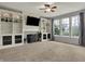 Open living room with built-in shelving, a fireplace, plush carpet, and natural light at 12027 Sellerton Dr, Fishers, IN 46037