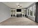 Spacious living room with built-in shelving, plush carpet, fireplace, and bright windows at 12027 Sellerton Dr, Fishers, IN 46037