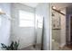 Elegant bathroom with large window, glass shower, and marble tiling creates a spa-like retreat at 12516 Schoolhouse Rd, Fishers, IN 46037