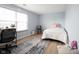 Inviting bedroom with natural light, neutral walls, and wood floors offers a cozy retreat at 12516 Schoolhouse Rd, Fishers, IN 46037
