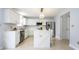 Modern kitchen with white cabinets, quartz countertops, stainless steel appliances, and an island with seating at 12516 Schoolhouse Rd, Fishers, IN 46037