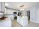 Modern kitchen featuring white cabinetry, quartz countertops, stainless steel appliances, and a stylish island with seating at 12516 Schoolhouse Rd, Fishers, IN 46037