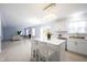 Spacious open-concept kitchen featuring a large island with seating and white cabinets at 12516 Schoolhouse Rd, Fishers, IN 46037