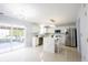 Bright, open-concept kitchen with stainless steel appliances, white cabinets, an island with seating, and an outdoor view at 12516 Schoolhouse Rd, Fishers, IN 46037