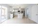 Modern kitchen with white cabinets, stainless steel appliances, marble countertops, and island with seating at 12516 Schoolhouse Rd, Fishers, IN 46037