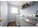 Laundry room featuring machines, utility shelving, and a bright window at 12516 Schoolhouse Rd, Fishers, IN 46037