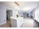 Open-concept living area with kitchen island flowing into a comfortable living room with natural light at 12516 Schoolhouse Rd, Fishers, IN 46037