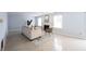 Bright living room features neutral walls, tile floors, a fireplace, and natural light at 12516 Schoolhouse Rd, Fishers, IN 46037
