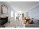 Bright living room featuring a fireplace, neutral walls, and tile floors that flow into the kitchen at 12516 Schoolhouse Rd, Fishers, IN 46037