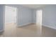 Bright living room featuring tile floors and an open doorway to the upper level at 12516 Schoolhouse Rd, Fishers, IN 46037