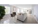 Bright living room featuring a fireplace, neutral walls, and tile floors that flow into the kitchen at 12516 Schoolhouse Rd, Fishers, IN 46037