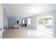 Bright living room featuring a fireplace, neutral walls, tile floors, and a sliding glass door at 12516 Schoolhouse Rd, Fishers, IN 46037