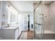 Luxurious main bathroom with marble counters, double sinks, and a glass-enclosed shower at 12516 Schoolhouse Rd, Fishers, IN 46037