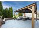 Outdoor covered patio with comfortable furniture, hardscape and landscaping at 12516 Schoolhouse Rd, Fishers, IN 46037